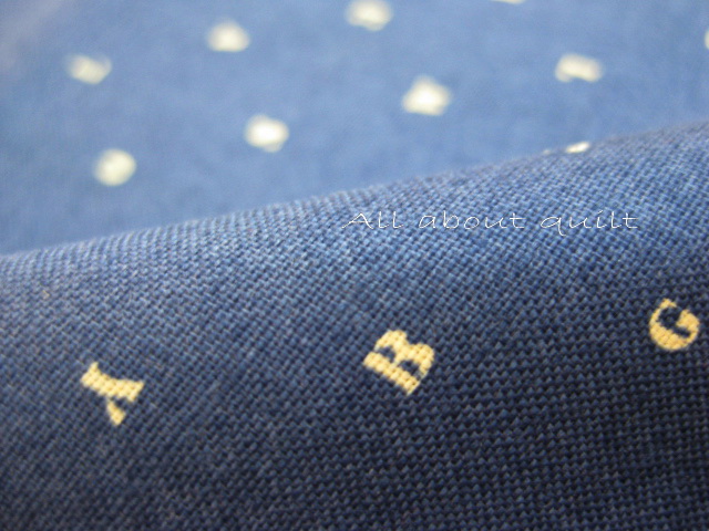 ผ้าcotton  ลาย little alphabet  พื้นน้ำเงิน สีขาว